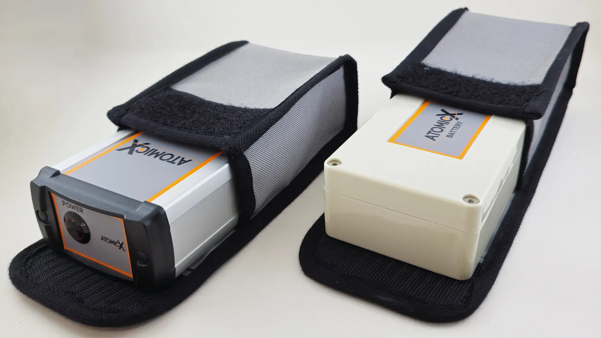 AtomicX Proton Magnetometer and AtomicX Battery in their protective cases